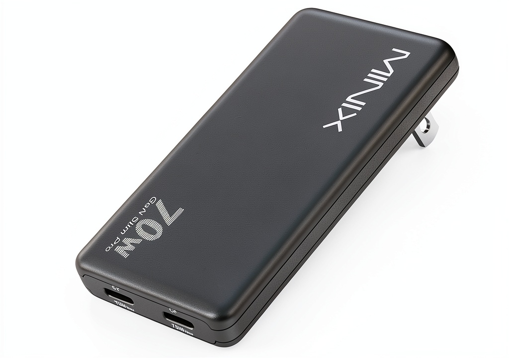 MINIX S70 GaN Charger 70W powering laptop and smartphone on travel desk